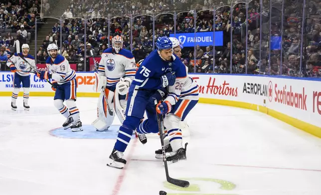 Toronto Maple Leafs right wing Ryan Reaves (75) collides with Edmonton Oilers defenseman Darnell Nurse (25) during the second period of an NHL hockey game, Saturday, Nov. 16, 2024 in Toronto. (Christopher Katsarov/The Canadian Press via AP)