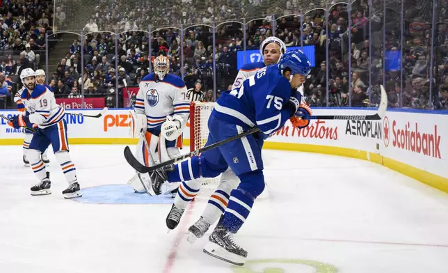 Toronto Maple Leafs right wing Ryan Reaves (75) collides with Edmonton Oilers defenseman Darnell Nurse (25) during the second period of an NHL hockey game, Saturday, Nov. 16, 2024 in Toronto. (Christopher Katsarov/The Canadian Press via AP)