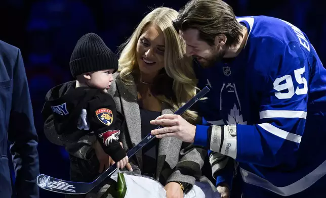 Toronto Maple Leafs defenseman Oliver Ekman-Larsson (95) celebrates with family while being honored in a pregame ceremony for 1000 league games ahead of an NHL hockey game against the Edmonton Oilers in Toronto, Saturday, Nov. 16, 2024. (Christopher Katsarov/The Canadian Press via AP)