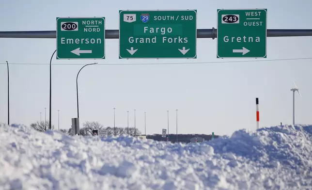 FILE - Road signage is posted just outside of Emerson, Manitoba, Jan. 20, 2022. (John Woods/The Canadian Press via AP, File)