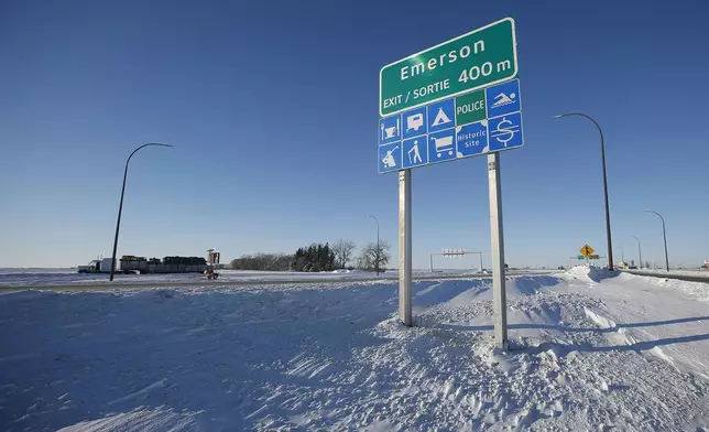 FILE - Road signage is posted just outside of Emerson, Manitoba on Thursday, Jan. 20, 2022. (John Woods/The Canadian Press via AP)