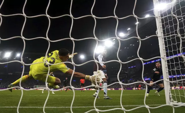 Aston Villa goalkeeper Emiliano Martinez makes a save on Juventus' Francisco Conceicao during the UEFA Champions League opening phase soccer stage match at Villa Park, Birmingham, England, Wednesday Nov. 27, 2024. (Nick Potts/PA via AP)