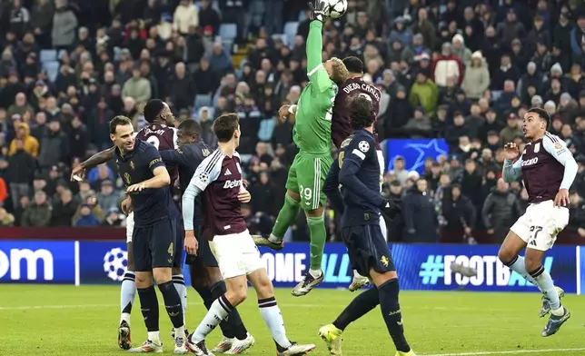 Aston Villa's Diego Carlos battles for the ball with Juventus goalkeeper Michele Di Gregorio during the UEFA Champions League opening phase soccer stage match at Villa Park, Birmingham, England, Wednesday Nov. 27, 2024. (David Davies/PA via AP)