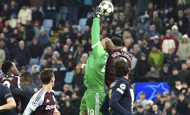 Aston Villa's Diego Carlos battles for the ball with Juventus goalkeeper Michele Di Gregorio during the UEFA Champions League opening phase soccer stage match at Villa Park, Birmingham, England, Wednesday Nov. 27, 2024. (David Davies/PA via AP)