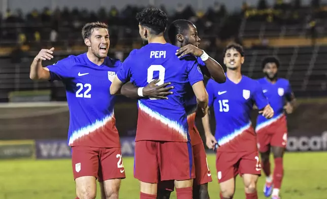 United States' Ricardo Pepi, center, celebrates scoring his side's first goal against Jamaica with teammates during a CONCACAF Nations League quarterfinal first leg soccer match in Kingston, Jamaica, Thursday, Nov. 14, 2024. (AP Photo/Collin Reid)