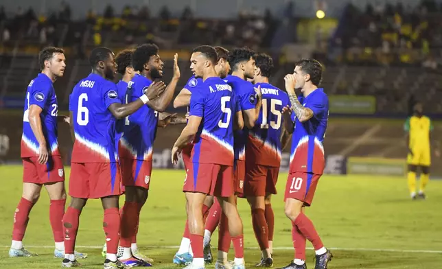 United States players celebrate scoring the opening goal against Jamaica during a CONCACAF Nations League quarterfinal first leg soccer match in Kingston, Jamaica, Thursday, Nov. 14, 2024. (AP Photo/Collin Reid)