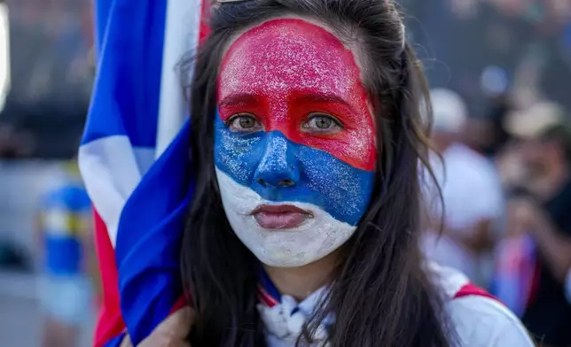 Claudia Noble stands outside the Broad Front's (Frente Amplio) election night headquarters after polls closed for the presidential run-off election in Montevideo, Uruguay, Sunday, Nov. 24, 2024. (AP Photo/Natacha Pisarenko)