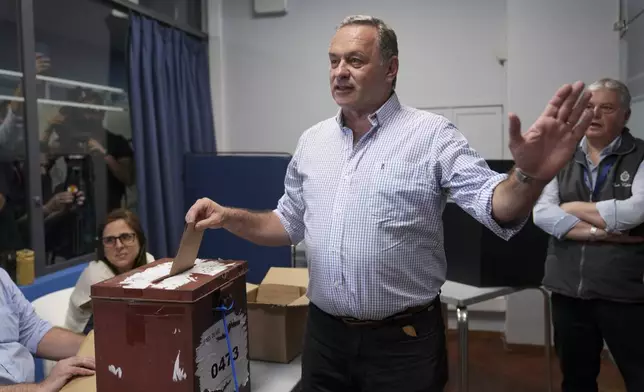 Alvaro Delgado, candidate for the ruling National Party, votes in the presidential run-off election in Montevideo, Uruguay, Sunday, Nov. 24, 2024. (AP Photo/Natacha Pisarenko)