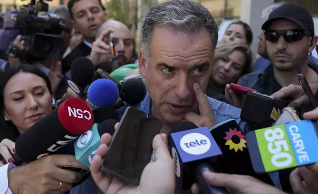 Yamandu Orsi, presidential candidate from the Frente Amplio (Broad Front), talks to journalists after voting in the presidential run-off election in Canelones, Uruguay, Sunday, Nov. 24, 2024. (AP Photo/Matilde Campodonico)