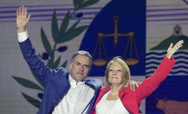 Yamandu Orsi, candidate for the Broad Front (Frente Amplio), and running mate Carolina Cosse, right, celebrate their victory in the presidential run-off election in Montevideo, Uruguay, Sunday, Nov. 24, 2024. (AP Photo/Natacha Pisarenko)