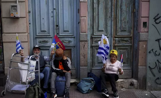 Supporters of Broad Front coalition presidential candidate Yamandu Orsi campaign one day ahead of the presidential run-off election, in Montevideo, Uruguay, Saturday, Nov. 23, 2024. (AP Photo/Natacha Pisarenko)