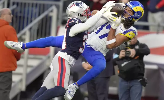 Los Angeles Rams wide receiver Puka Nacua (17) tries to hang onto the ball as New England Patriots cornerback Jonathan Jones (31) begins to knock the ball free during the second half of an NFL football game, Sunday, Nov. 17, 2024, in Foxborough, Mass. (AP Photo/Steven Senne)