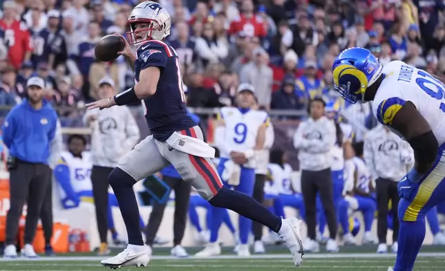 New England Patriots quarterback Drake Maye (10) runs against the Los Angeles Rams during the first half of an NFL football game, Sunday, Nov. 17, 2024, in Foxborough, Mass. (AP Photo/Michael Dwyer)