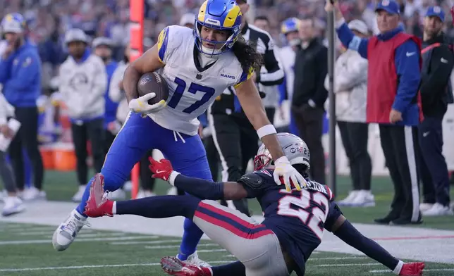 Los Angeles Rams wide receiver Puka Nacua (17) eludes New England Patriots cornerback Marco Wilson (22) during the first half of an NFL football game, Sunday, Nov. 17, 2024, in Foxborough, Mass. (AP Photo/Steven Senne)