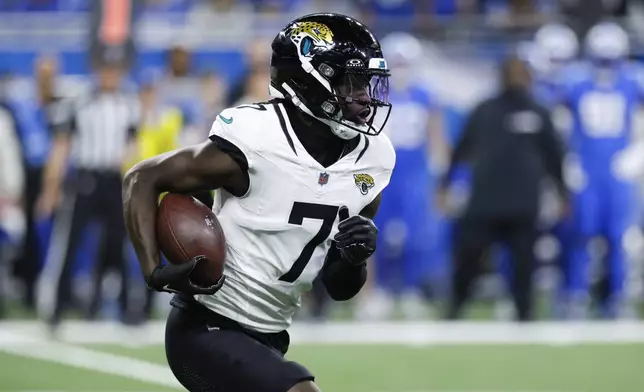 Jacksonville Jaguars wide receiver Brian Thomas Jr. (7) runs the ball against the Detroit Lions during the first half of an NFL football game, Sunday, Nov. 17, 2024, in Detroit. (AP Photo/Duane Burleson)