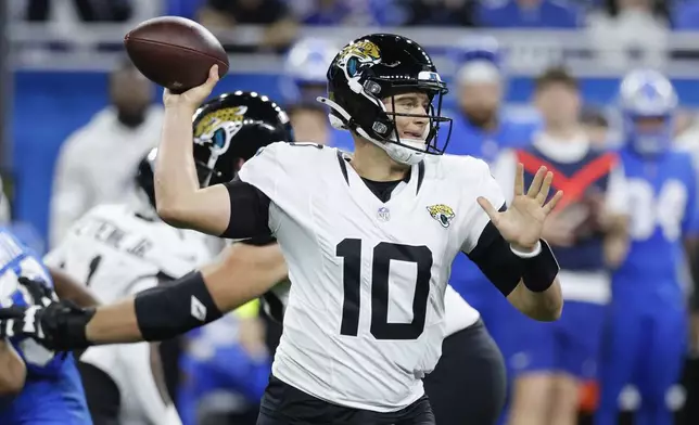 Jacksonville Jaguars quarterback Mac Jones (10) throws against the Detroit Lions during the first half of an NFL football game, Sunday, Nov. 17, 2024, in Detroit. (AP Photo/Duane Burleson)