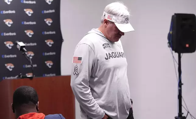 Jacksonville Jaguars head coach Doug Pederson leaves after talking to the media after an NFL football game against the Detroit Lions, Sunday, Nov. 17, 2024, in Detroit. (AP Photo/Carlos Osorio)