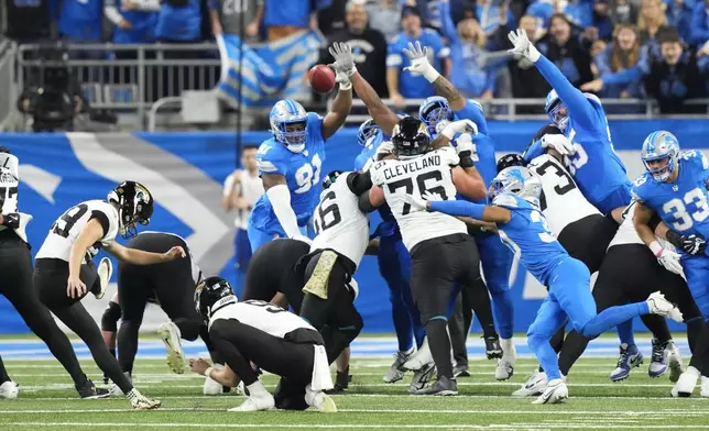 Jacksonville Jaguars place-kicker Cam Little (39) kicks a 35-yard field goal against the Detroit Lions during the first half of an NFL football game, Sunday, Nov. 17, 2024, in Detroit. (AP Photo/Carlos Osorio)