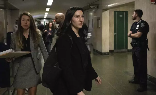 Dr. Cynthia Harris, forensic pathologist at the Office of the City Medical Examiner, leaves the courtroom for a lunch break in New York, Monday, Nov. 18, 2024. (AP Photo/Yuki Iwamura)