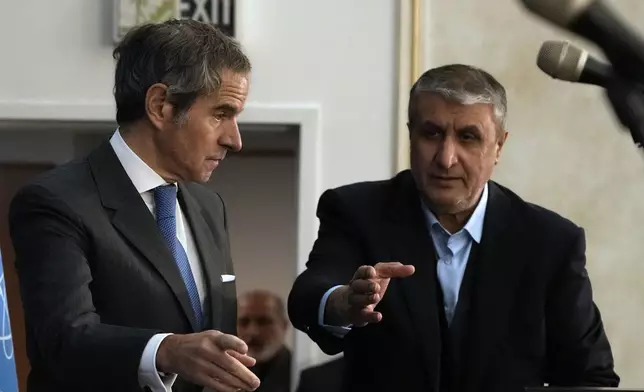 International Atomic Energy Agency, IAEA, Director General Rafael Mariano Grossi, left, and head of Atomic Energy Organization of Iran Mohammad Eslami gesture as they arrive for a press conference in Tehran, Iran, Thursday, Nov. 14, 2024. (AP Photo/Vahid Salemi)