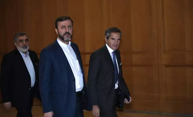 International Atomic Energy Agency (IAEA) Director General Rafael Mariano Grossi, right, arrives for a meeting with Iranian Foreign Minister Abbas Araghchi, unseen, as he is accompanied by Deputy Foreign Minister Kazem Gharib Abadi, second right, and Deputy Chief of Atomic Energy Organization of Iran, Behrouz Kamalvandi in Tehran, Iran, Thursday, Nov. 14, 2024. (AP Photo/Vahid Salemi)