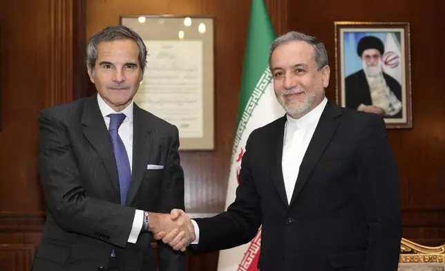 International Atomic Energy Agency (IAEA) Director General Rafael Mariano Grossi, left, shakes hands with Iranian Foreign Minister Abbas Araghchi during their meeting in Tehran, Iran, Thursday, Nov. 14, 2024. (AP Photo/Vahid Salemi)