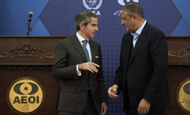 International Atomic Energy Agency, IAEA, Director General Rafael Mariano Grossi, left, talks with Iran's Atomic Energy Organization head Mohammad Eslami at the conclusion of their press conference in Tehran, Iran, Thursday, Nov. 14, 2024. (AP Photo/Vahid Salemi)