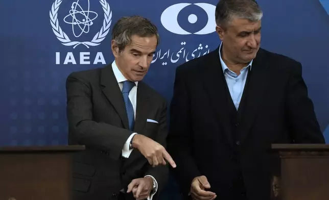 International Atomic Energy Agency, IAEA, Director General Rafael Mariano Grossi, left, gestures at the conclusion of his joint press conference with Iran's Atomic Energy Organization head Mohammad Eslami in Tehran, Iran, Thursday, Nov. 14, 2024. (AP Photo/Vahid Salemi)