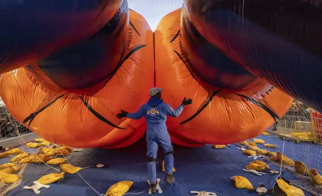 A person inflates a float of Goku in preparation for the Macy's Thanksgiving Day Parade, Wednesday, Nov. 27, 2024, in New York. (AP Photo/Yuki Iwamura)