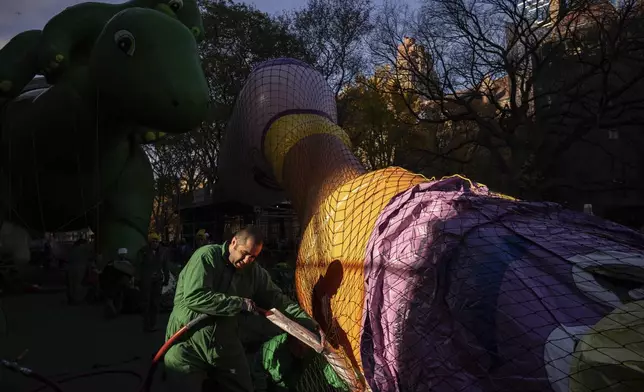 A person inflates a float in preparation for the Macy's Thanksgiving Day Parade, Wednesday, Nov. 27, 2024, in New York. (AP Photo/Yuki Iwamura)