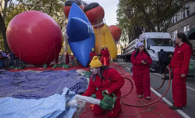 A person inflates a float of Bluey in preparation for the Macy's Thanksgiving Day Parade, Wednesday, Nov. 27, 2024, in New York. (AP Photo/Yuki Iwamura)