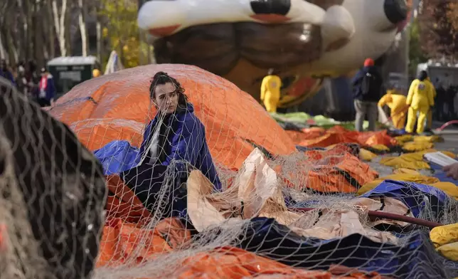 Ash Ditaranto helps to inflate a float in preparation for the Macy's Thanksgiving Day Parade in New York, Wednesday, Nov. 27, 2024. (AP Photo/Seth Wenig)