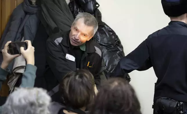 Imprisoned Kremlin critic Alexei Gorinov, is escorted to the court as his second trial for criticizing Russia's actions in Ukraine swiftly nears its conclusion in Vladimir, Russia, Friday, Nov. 29, 2024. (AP Photo/Dmitry Serebryakov)