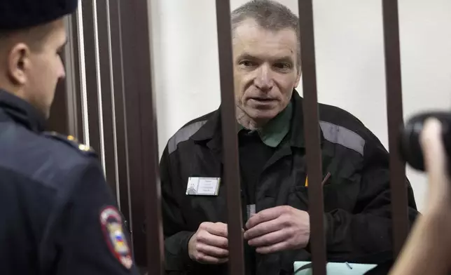 Imprisoned Kremlin critic Alexei Gorinov, standing in a cage appears in court as his second trial for criticizing Russia's actions in Ukraine swiftly nears its conclusion in Vladimir, Russia, Friday, Nov. 29, 2024. (AP Photo/Dmitry Serebryakov)