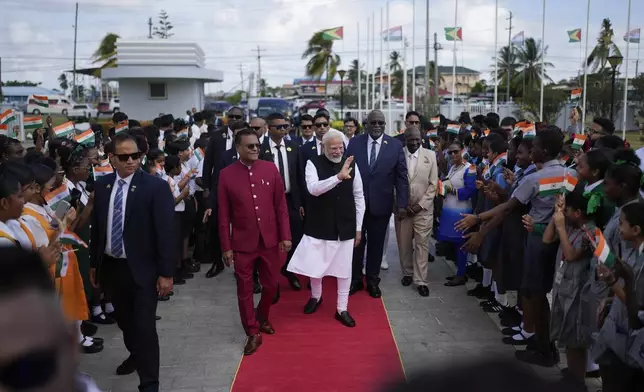 India's Prime Minister Narendra Modi waves as he arrives to Parliament in Georgetown, Guyana, Thursday, Nov. 21, 2024. (AP Photo/Matias Delacroix)