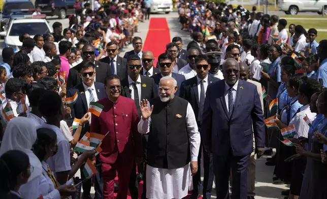 India's Prime Minister Narendra Modi waves as he arrives to Parliament in Georgetown, Guyana, Thursday, Nov. 21, 2024. (AP Photo/Matias Delacroix)