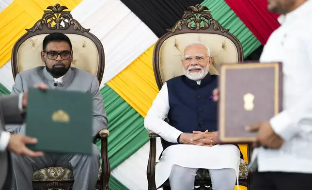 Guyana's President Mohammed Irfaan Ali, left, and India's Prime Minister Narendra Modi, attend a meeting at Government House in Georgetown, Guyana, Wednesday, Nov. 20, 2024. (AP Photo/Matias Delacroix)