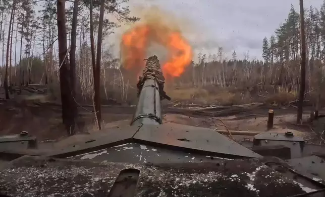 In this photo taken from a video released by Russian Defense Ministry press service no Friday, Nov. 22, 2024, Russian T90M Proryv tank fires towards Ukrainian positions at an undisclosed location in Ukraine. (Russian Defense Ministry Press Service via AP)