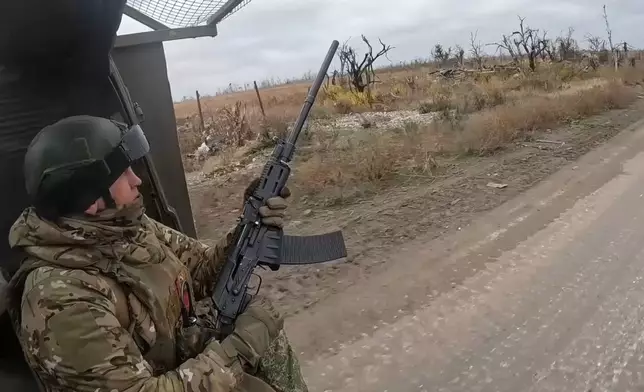 In this photo taken from a video released by Russian Defense Ministry Press Service on Friday, Nov. 22, 2024, a Russian engineer troops serviceman operates at an undisclosed location in Ukraine. (Russian Defense Ministry Press Service via AP)