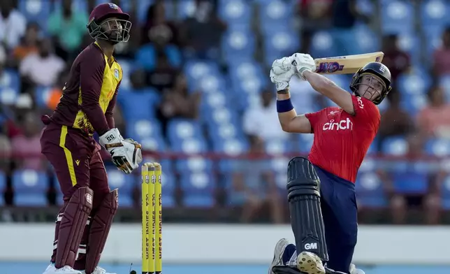 England's Jacob Bethell plays a shot for six runs from the bowling of West Indies' Gudakesh Motie during the fourth T20 cricket match at Daren Sammy National Cricket Stadium in Gros Islet, St. Lucia, Saturday, Nov. 16, 2024. (AP Photo/Ricardo Mazalan)