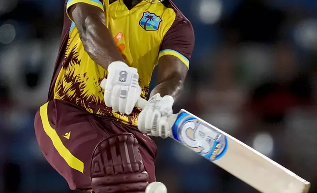 West Indies' Evin Lewis plays a shot against England during the fourth T20 cricket match at Daren Sammy National Cricket Stadium in Gros Islet, St. Lucia, Saturday, Nov. 16, 2024. (AP Photo/Ricardo Mazalan)