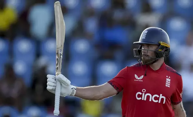 England's Phil Salt acknowledges scoring half a century against West Indies during the fourth T20 cricket match at Daren Sammy National Cricket Stadium in Gros Islet, St. Lucia, Saturday, Nov. 16, 2024. (AP Photo/Ricardo Mazalan)