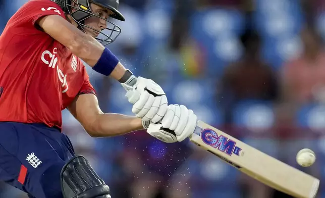 England's Jacob Bethell hits a third six in a row from the bowling of West Indies' Roston Chase during the fourth T20 cricket match at Daren Sammy National Cricket Stadium in Gros Islet, St. Lucia, Saturday, Nov. 16, 2024. (AP Photo/Ricardo Mazalan)