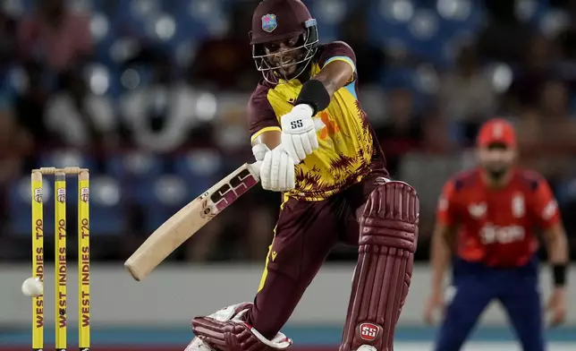 West Indies' Shai Hope plays a shot from a delivery of England's Sam Curran during the fourth T20 cricket match at Daren Sammy National Cricket Stadium in Gros Islet, St. Lucia, Saturday, Nov. 16, 2024. (AP Photo/Ricardo Mazalan)