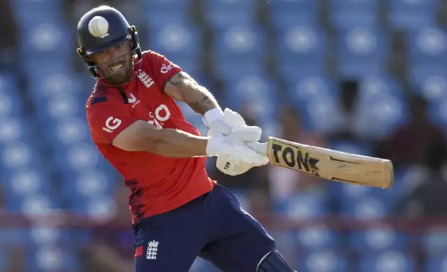 England's Phil Salt plays a shot for four runs from the bowling of West Indies' Akeal Hosein during the fourth T20 cricket match at Daren Sammy National Cricket Stadium in Gros Islet, St. Lucia, Saturday, Nov. 16, 2024. (AP Photo/Ricardo Mazalan)