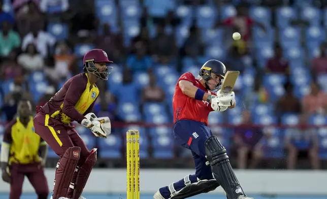 England's Jacob Bethell hits a third six in a row from the bowling of West Indies' Roston Chase during the fourth T20 cricket match at Daren Sammy National Cricket Stadium in Gros Islet, St. Lucia, Saturday, Nov. 16, 2024. (AP Photo/Ricardo Mazalan)