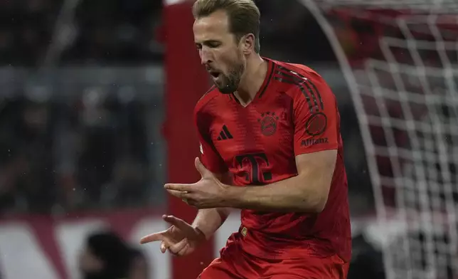 Bayern's Harry Kane celebrates after scoring the opening goal with the penalty kick during the Bundesliga soccer match between Bayern Munich and Augsburg at the Allianz Arena in Munich, Germany, Friday, Nov. 22, 2024. (AP Photo/Matthias Schrader)