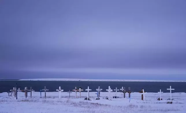 Grave markers are seen at the village's cemetery facing the Kaktovik Lagoon and the coastal plain of the Arctic National Wildlife Refuge Monday, Oct. 14, 2024, in Kaktovik, Alaska. (AP Photo/Lindsey Wasson)