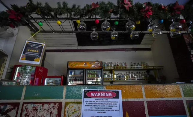 A notice displayed at the bar of Nana Backpack hostel in Vang Vieng, Laos, Tuesday, Nov. 19, 2024. (AP Photo/Anupam Nath)