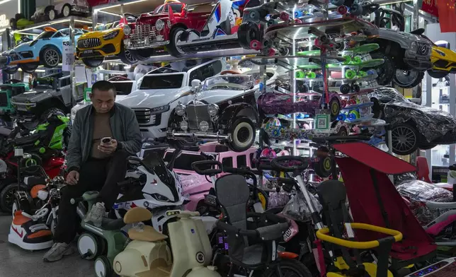 A vendor waits for customers at his store selling electric toy cars at the Yiwu wholesale market in Yiwu, east China's Zhejiang province on Nov. 8, 2024. (AP Photo/Andy Wong)